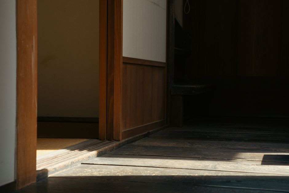 Zen-inspired minimalistic Japanese room featuring wooden panels and tatami mats.